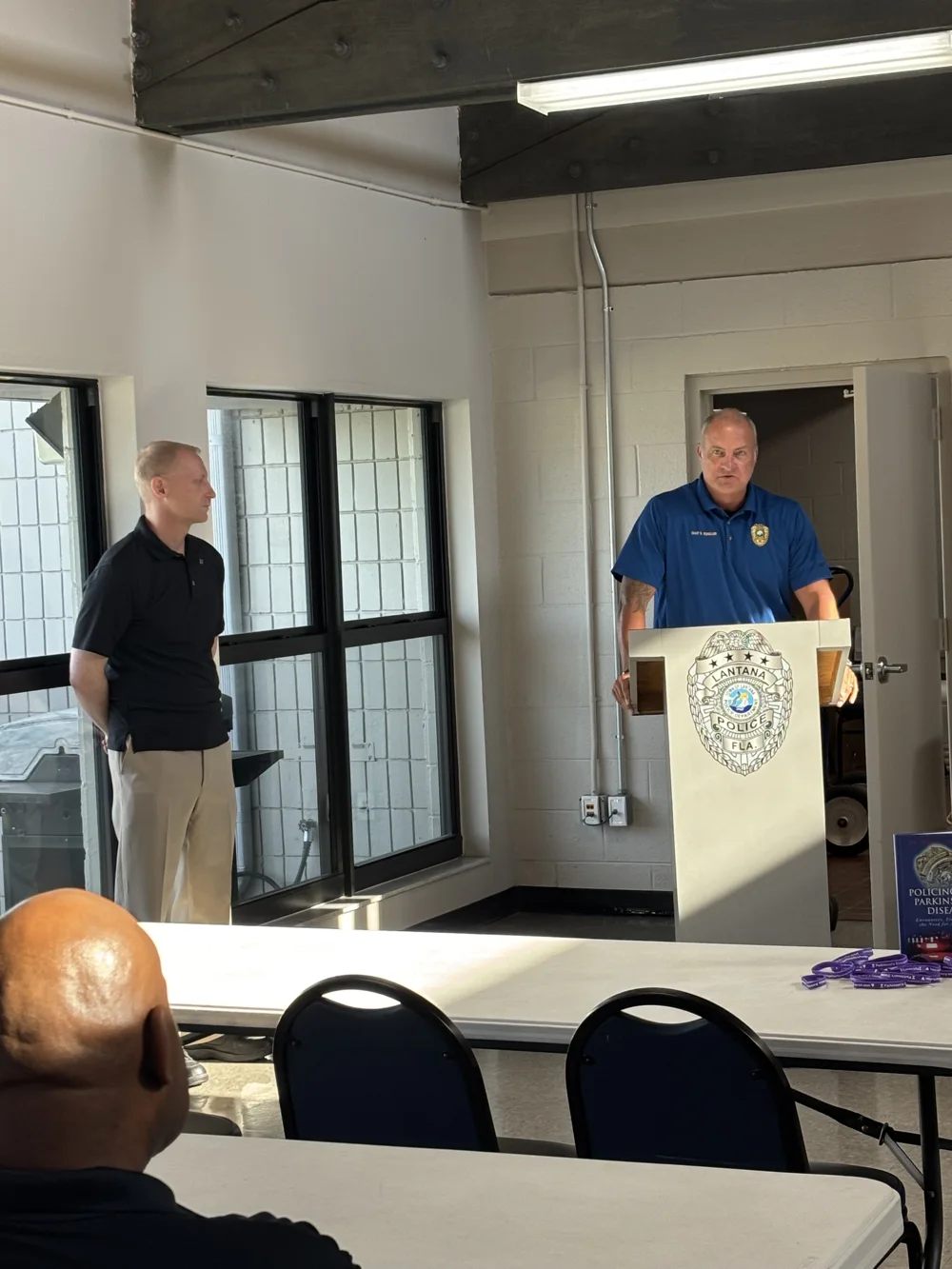 Dr. Ackerman presenting at a podium to police officers