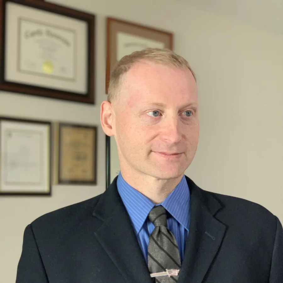 Dr. George Ackerman in a suit and tie